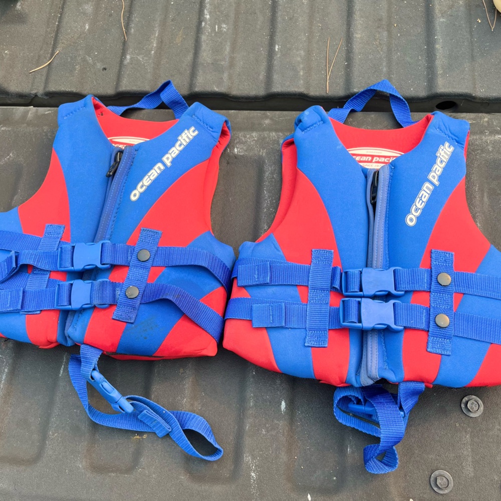 Pair of kids lifejackets by ocean Pacific
